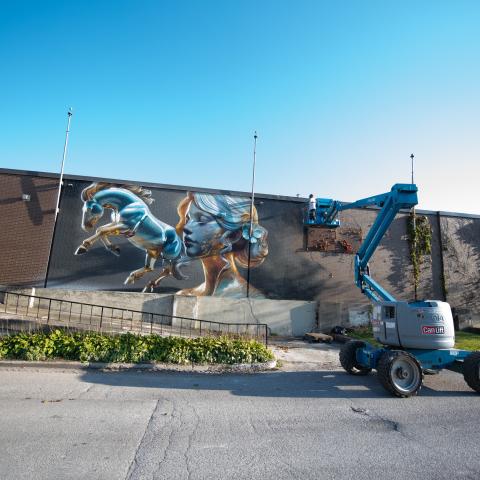 The street artist named Bacon, who is widely regarded as Canada’s top spray painter, created a mega-mural on the walls of the Western Fair District